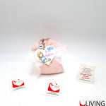 bomboniera linea solidale lilt living sacchetto con portachiavi bimba battesimo
